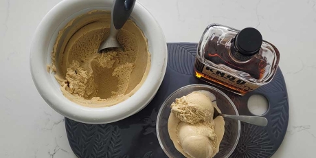 Bourbon Vanilla Ice Cream on a tray with a bottle of bourbon.