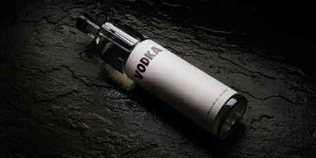 Vodka bottle lying on a black table.