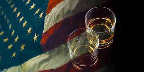 Two glasses of whiskey with an American flag.