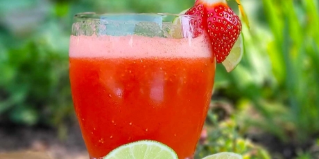 Strawberry Lime Fizz cocktail with fresh limes.