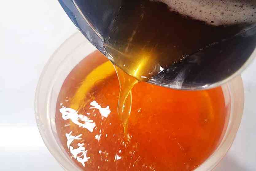 Pouring browned-butter into whiskey.