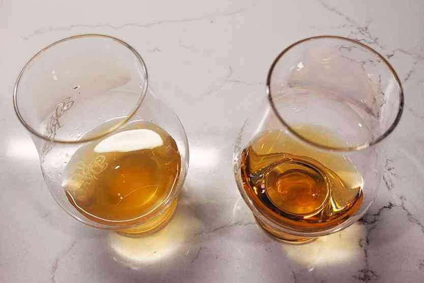 Browned-butter whiskey next to clear whiskey to show colour comparison.