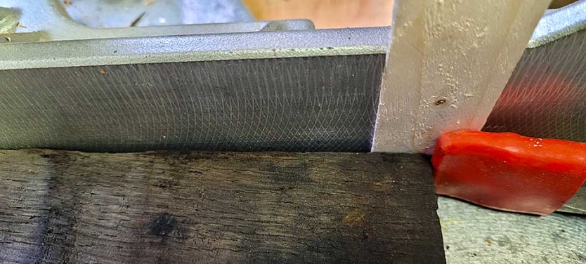 Stave on a miter saw with a shim for alignment.
